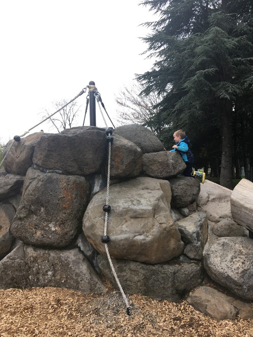 Julian climbing rocks.