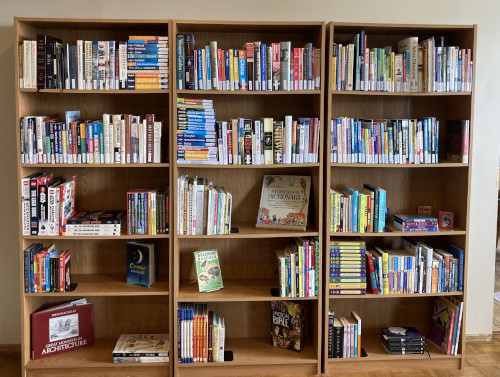 Three book cases side-by-side with books.