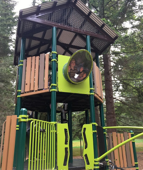 Julian looking down from the top level of play structure.