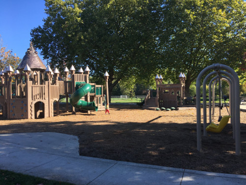 South side of playground with playground structures and swings.