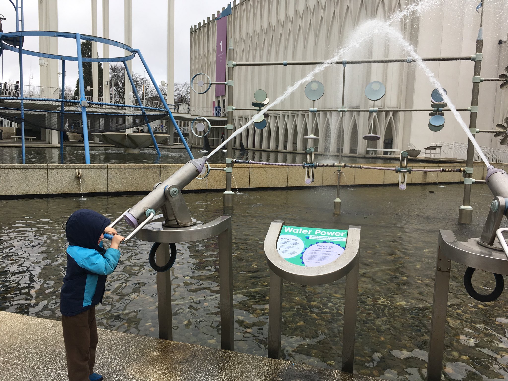 Julian aiming a water canon across the artificial pond at the Pacific Science Center.