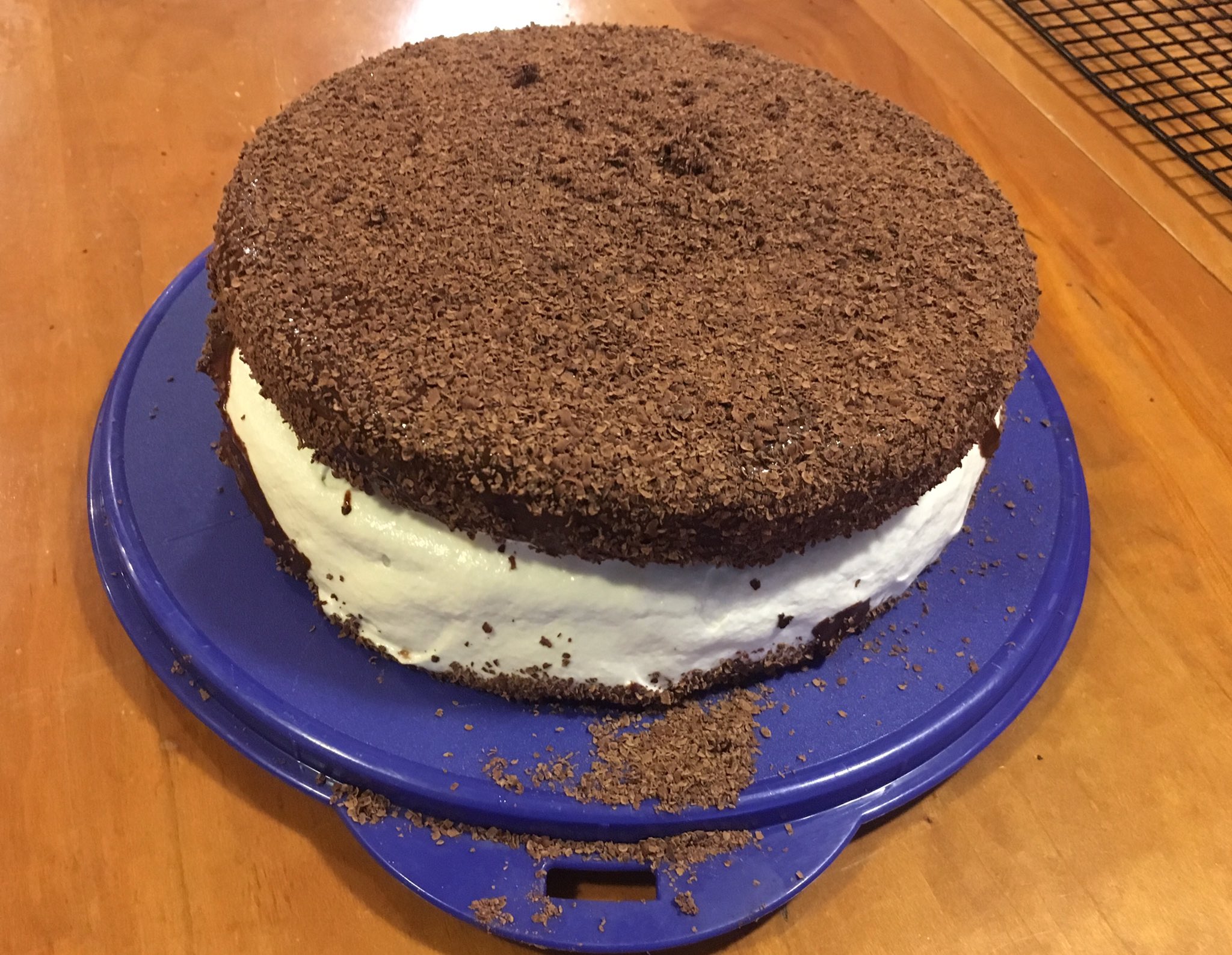 Two layer chocolate cake with white marshmallow fluff oozing out of the middle.