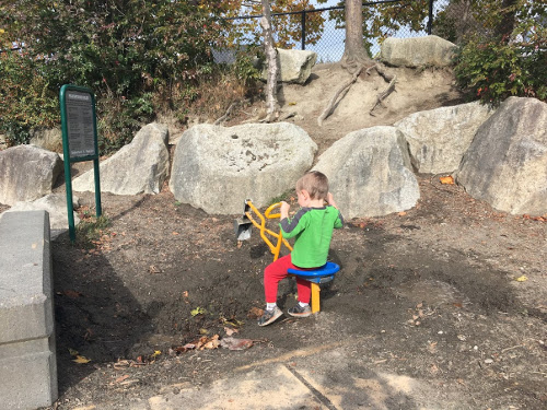 Julian using the digger to dig mud.