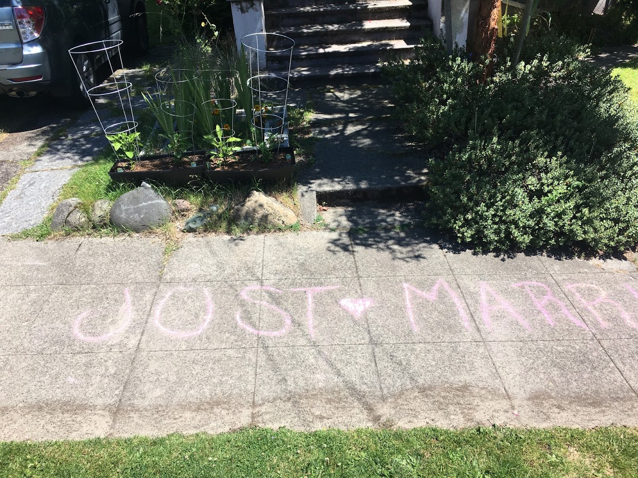 Chalk on sidewalk that says Just Married.