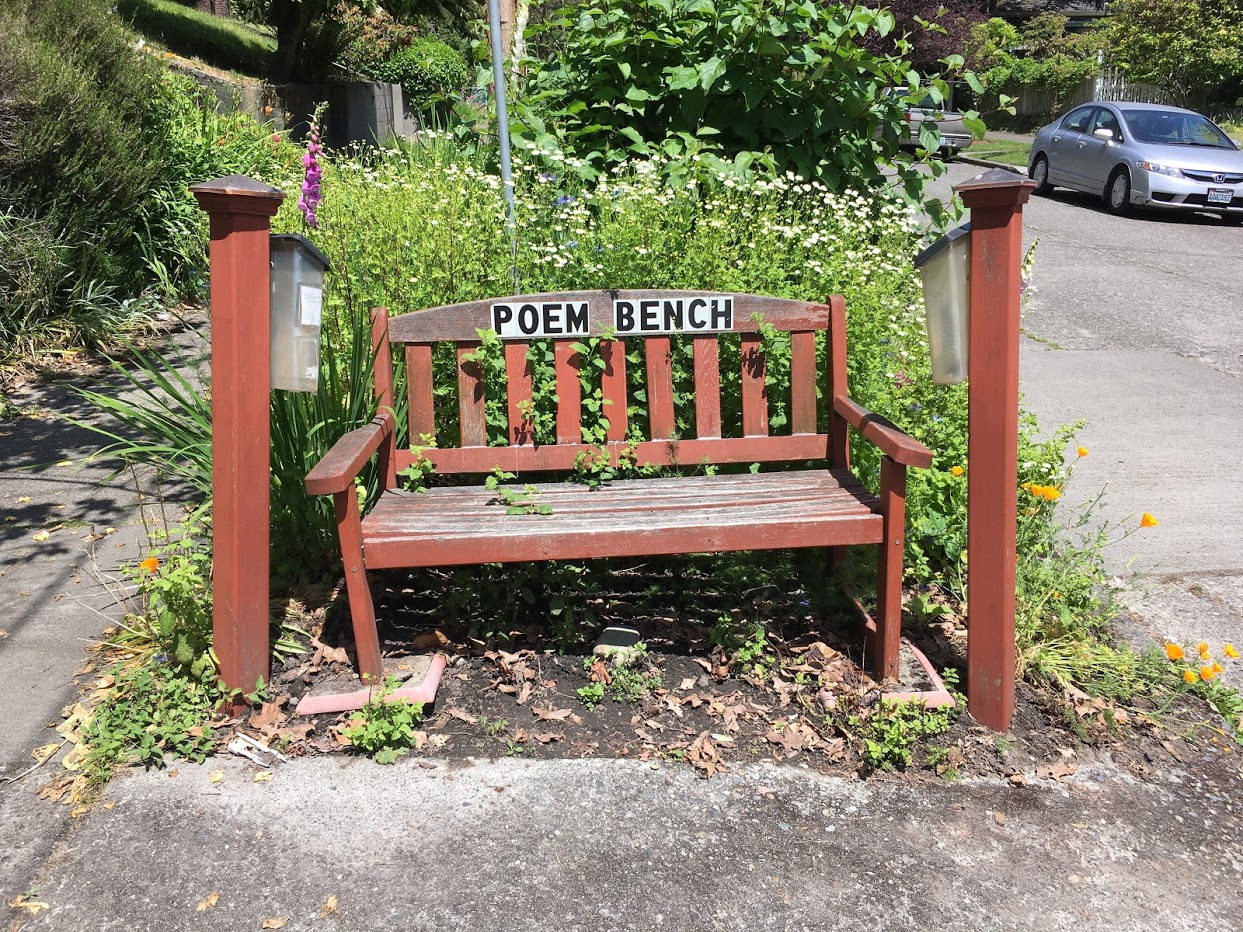 Bench with words that say "Poem bench" on it.