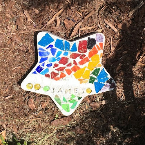 Colorful mosaic star with the word James on it.